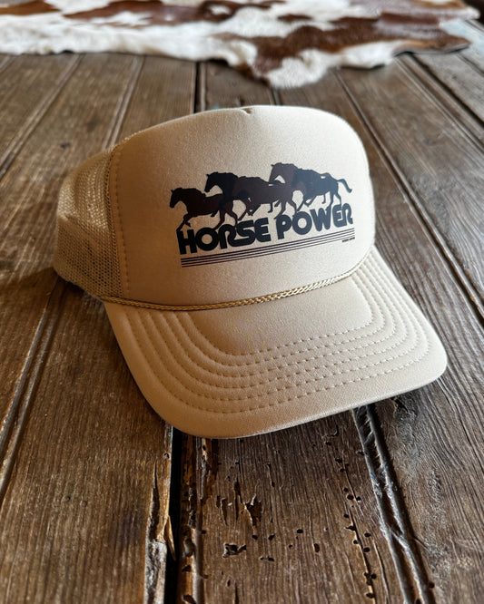 Beige cap with 'Horse Power' logo on a wooden surface
