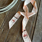 Ribbon scarf with buffalos with rustic wooden background and a rope 