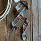 Horseshoe ribbon scarf on a rustic background with a rope