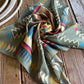 Colorful patterned scarf on a wooden surface