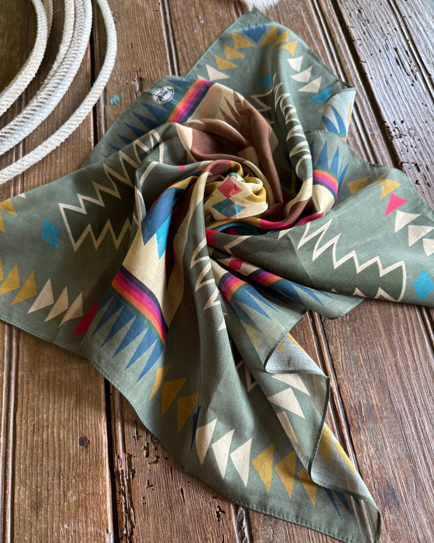 Colorful patterned scarf on a wooden surface