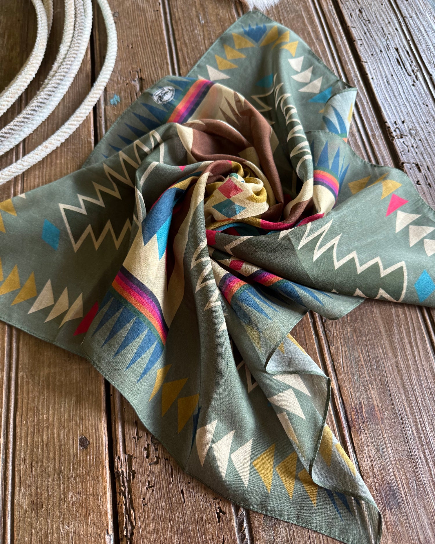 Colorful patterned scarf on a wooden surface