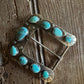 Horse shoe buckle 6 with turquoise on rustic wood background
