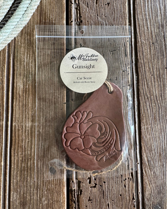 Brown leather car scent with floral design on a wooden surface