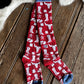 Red socks with white patterns on a wooden floor