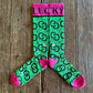 High Maintenance Cowgirl Performance Socks (Kelly Green/Pink) showing design on rustic wood background 