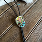 Necklace with a heart-shaped pendant featuring a cartoon character on a wooden surface.