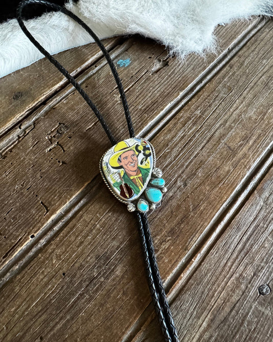 Necklace with a heart-shaped pendant featuring a cartoon character on a wooden surface.