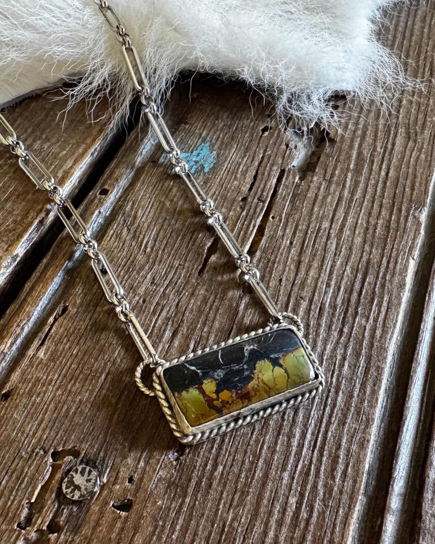 blackjack turquoise necklace on a rustic wooden background