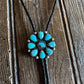 Turquoise stone necklace on a wooden surface