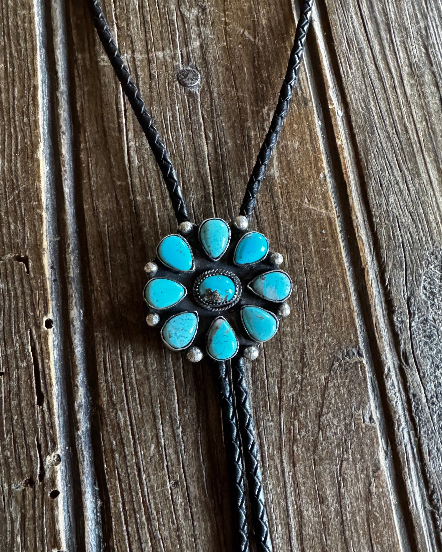 Turquoise stone necklace on a wooden surface