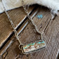Necklace with a pendant on a wooden surface