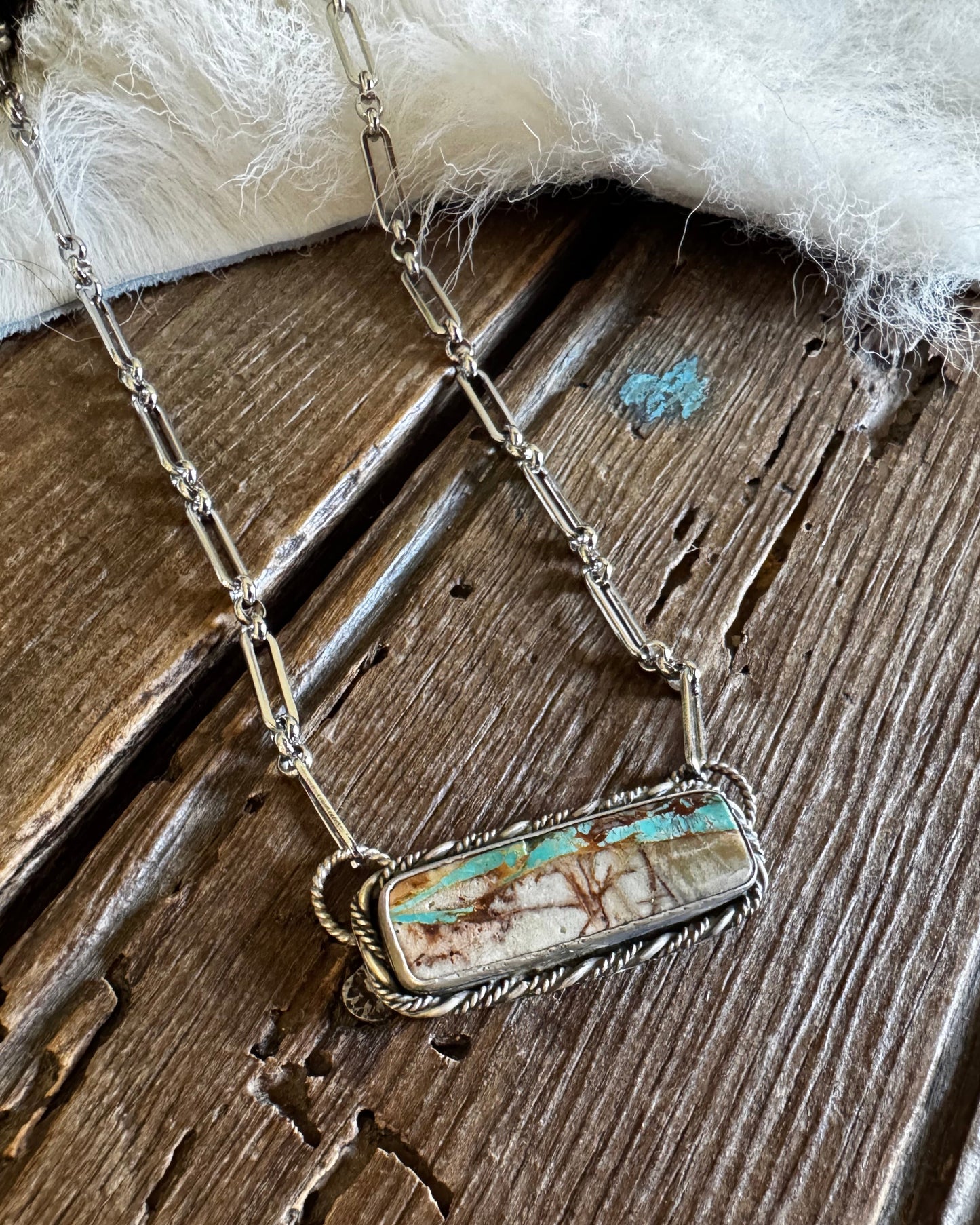 Necklace with a pendant on a wooden surface