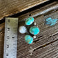Turquoise hat slide on a wooden surface with a ruler for scale.