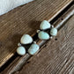 Silver earrings with white stones on a wooden surface