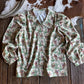 Retro cowboy and cactus patterned shirt on a wooden surface with a cowhide rug