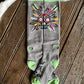 Gray sock with colorful design on a wooden floor