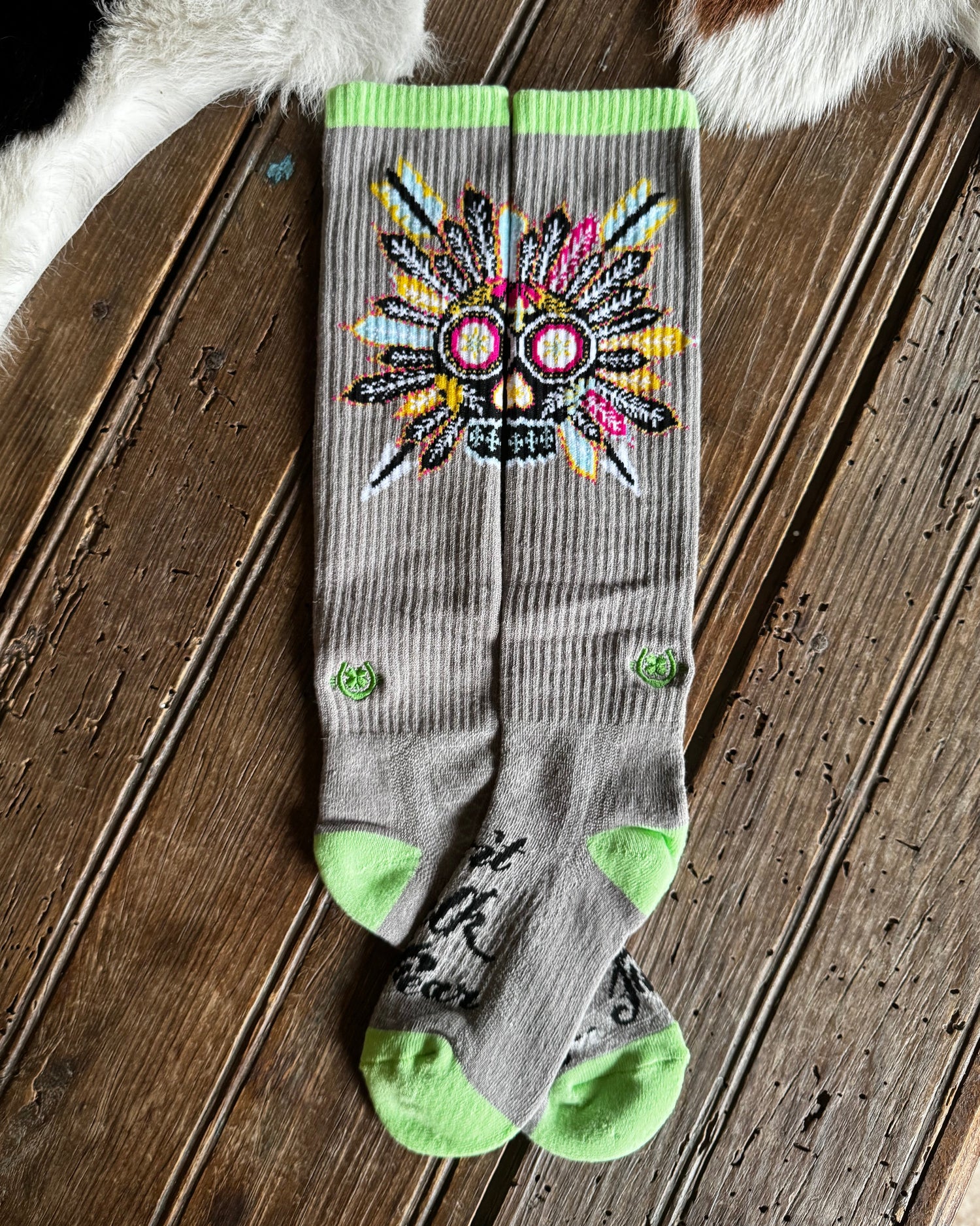 Gray sock with colorful design on a wooden floor