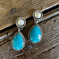 Fox turquoise and silver earrings on a rustic wooden background