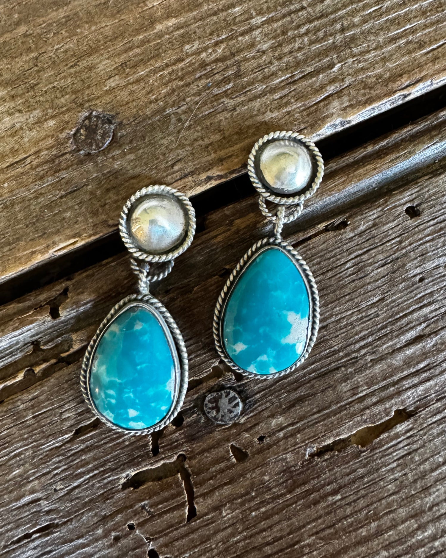 Fox turquoise and silver earrings on a rustic wooden background
