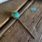 Turquoise stone necklace on a wooden surface