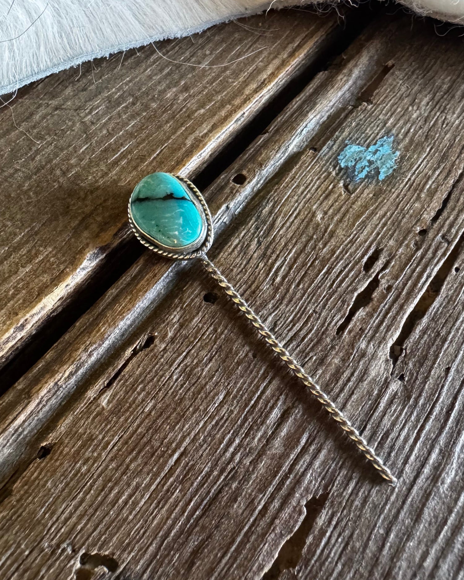 Turquoise stone necklace on a wooden surface