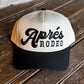Cap with 'Aperés Rodeo' logo on a wooden surface
