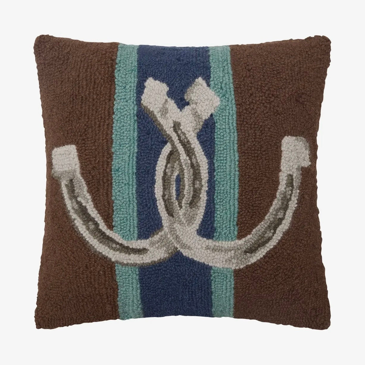 Decorative pillow with horse shoes and striped pattern on a brown background