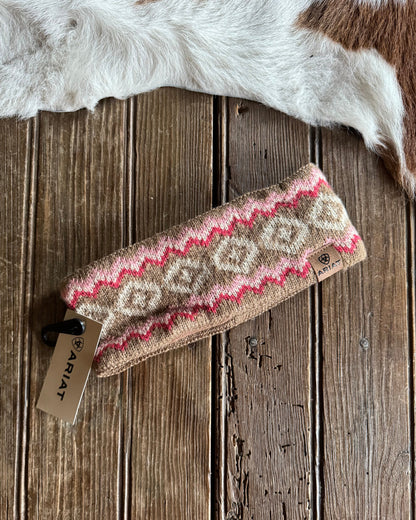Knitted headband with a pattern on a wooden surface, Ariat tag visible