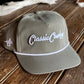 Gray cap with 'Classic Cowboy' logo on a wooden surface