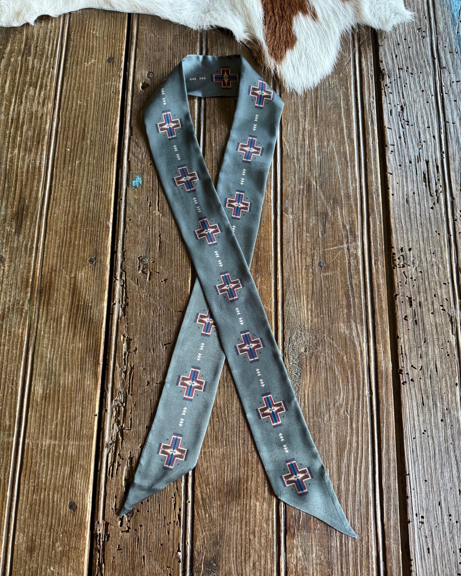 grey scarf with pattern on a wooden surface