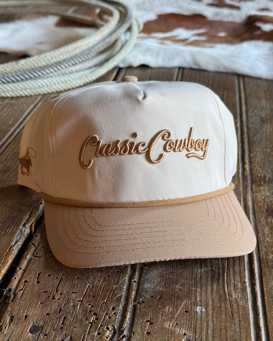 Beige cap with 'Classic Cowboy' logo on a wooden surface