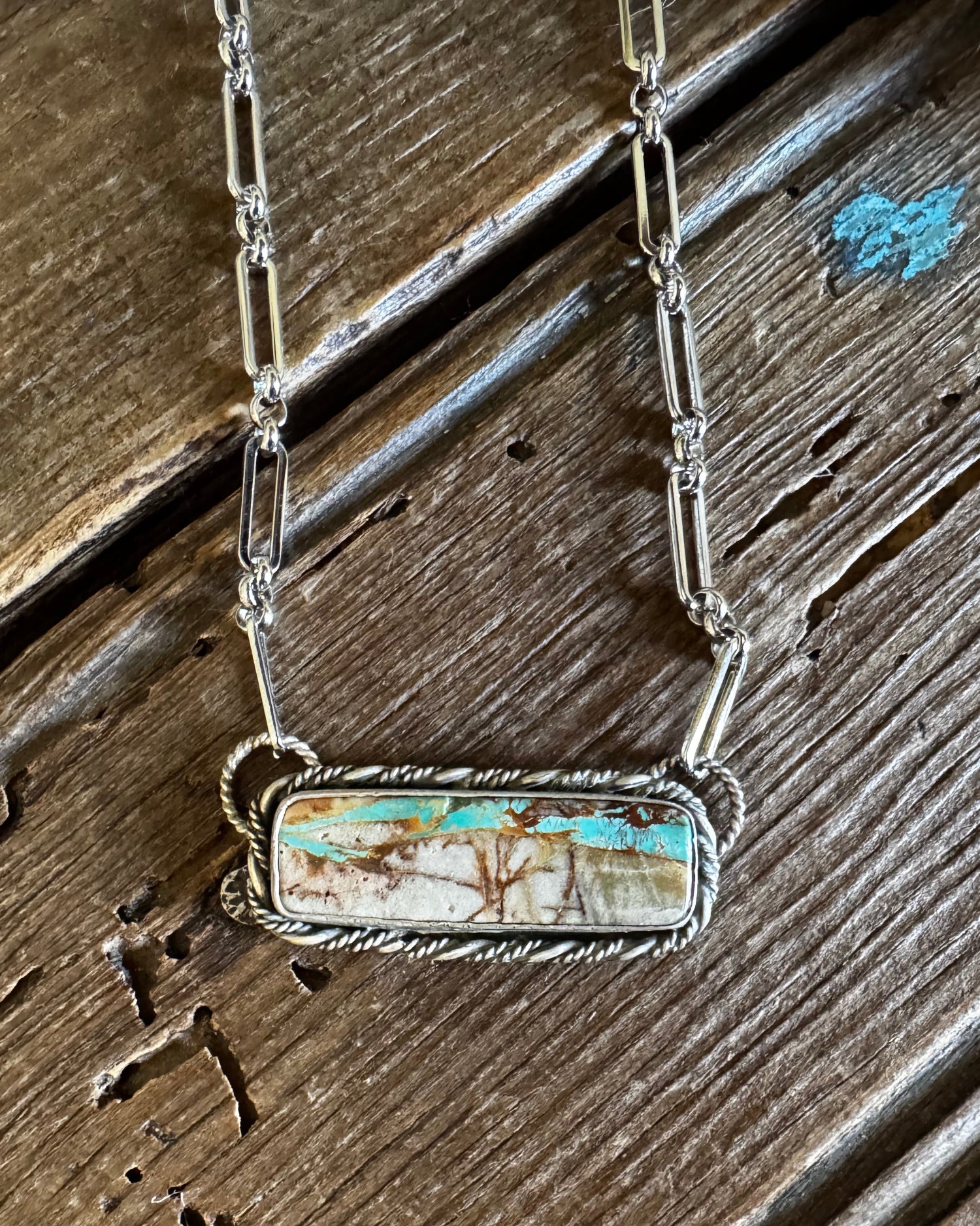 Royston Ribbon turquoise necklace on a rustic wooden background
