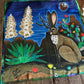 Scarf with a colorful design of a jackalope and nature elements on a wooden surface.