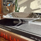 Silver tray on top of a book with 'Chanel' branding
