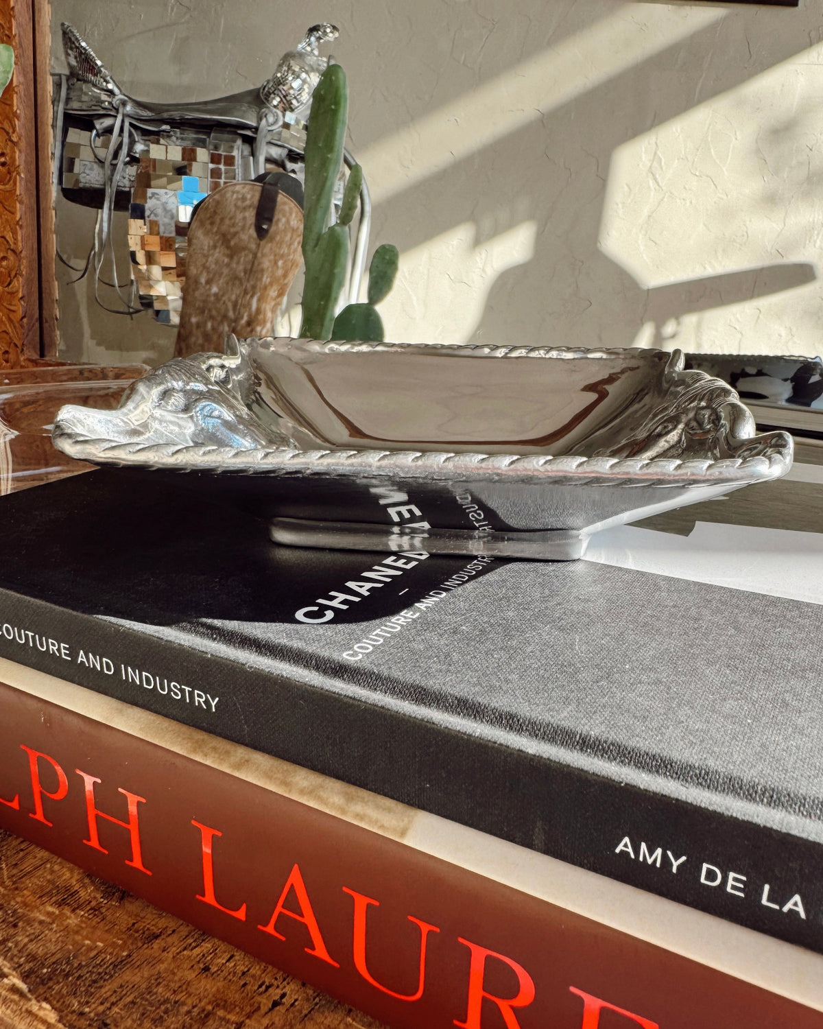 Silver tray on top of a book with 'Chanel' branding