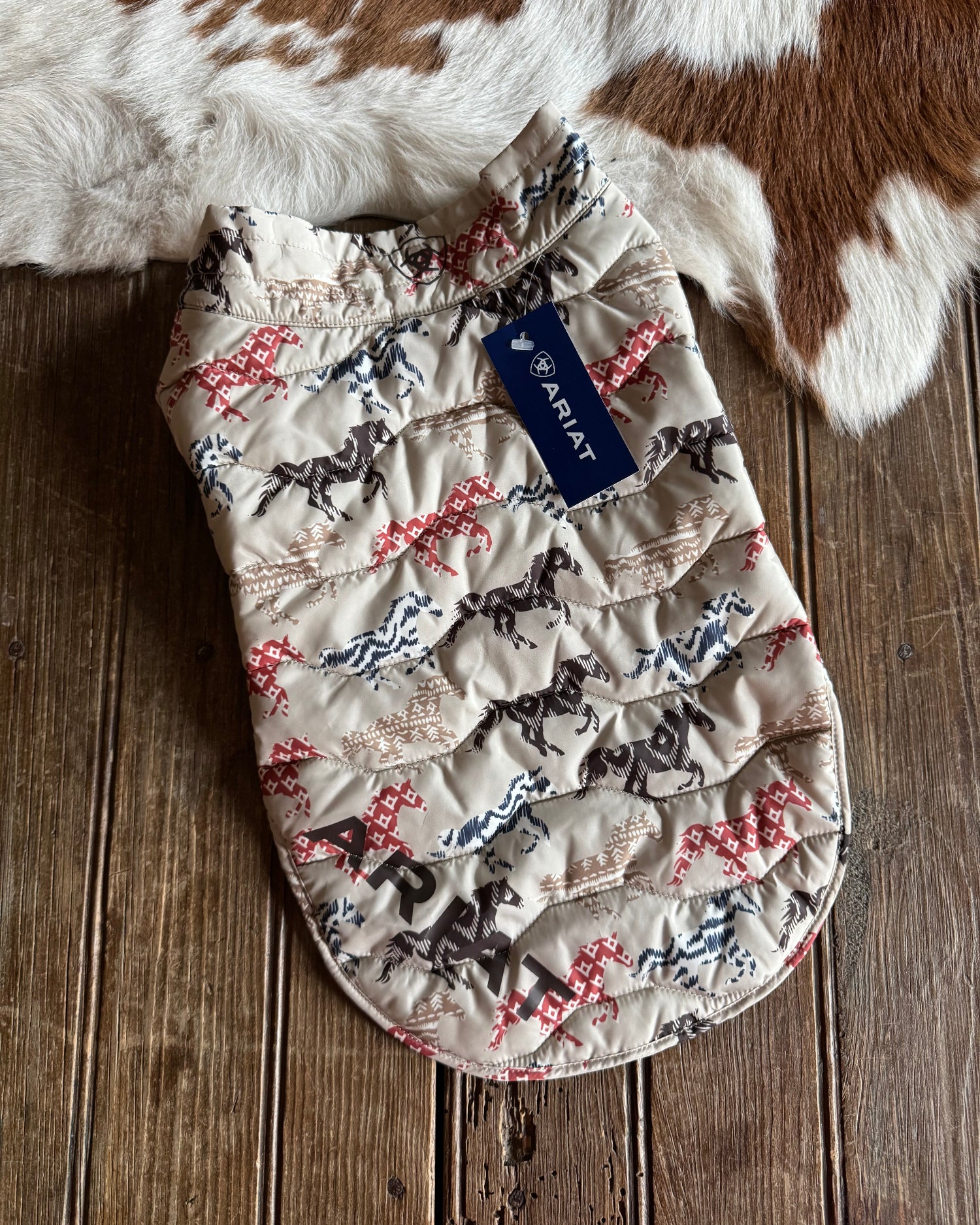 Quilted product with Ariat logo on a wooden surface