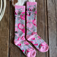 Pink and gray patterned socks on a wooden surface 