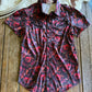 Red and black patterned shirt on a wooden surface