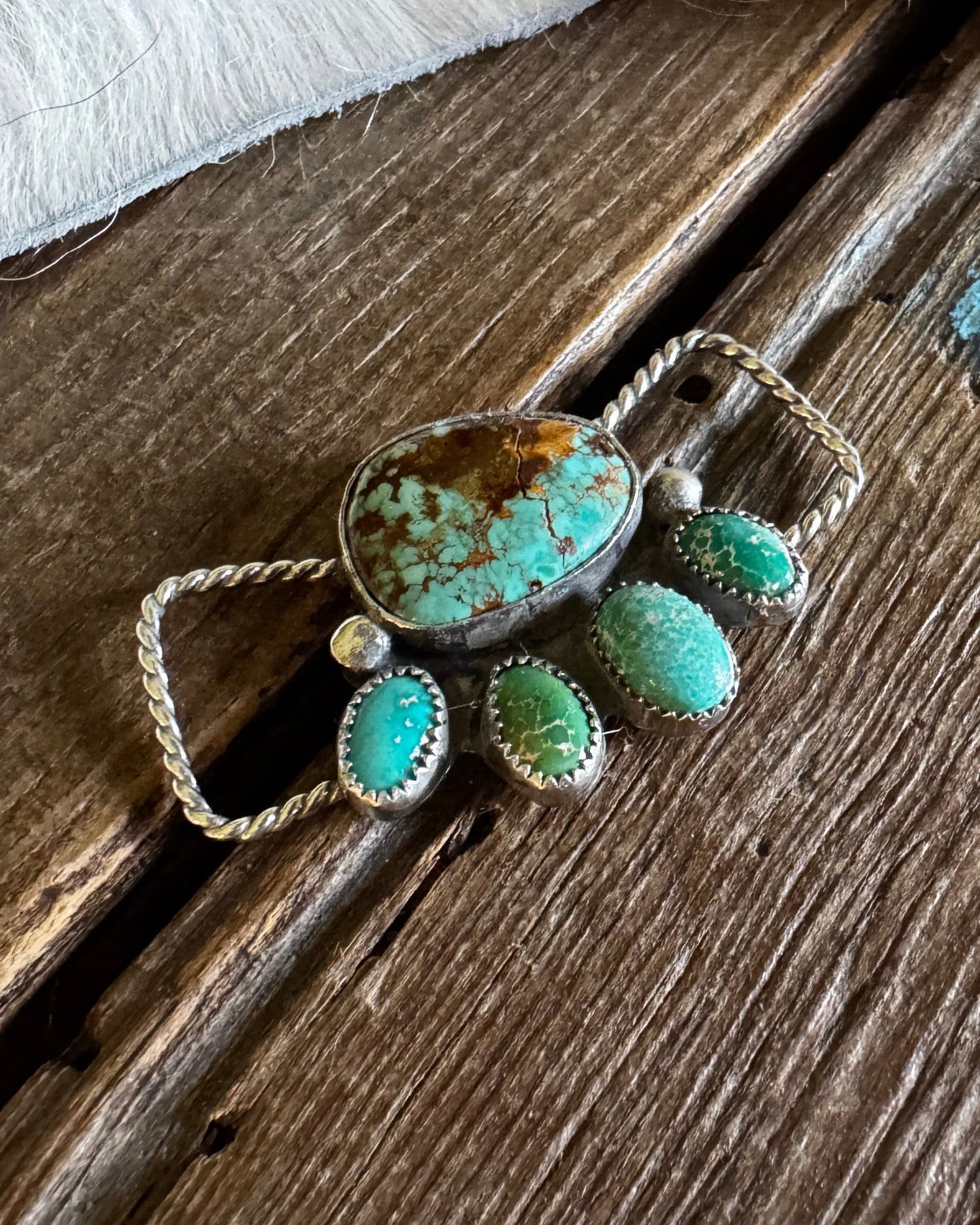 Turquoise twilly slide on a wooden surface