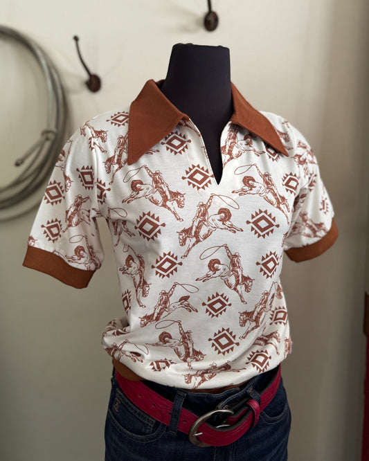 White shirt with brown pattern on a mannequin against a neutral background
