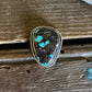 Turquoise scarf slide ring on a wooden surface