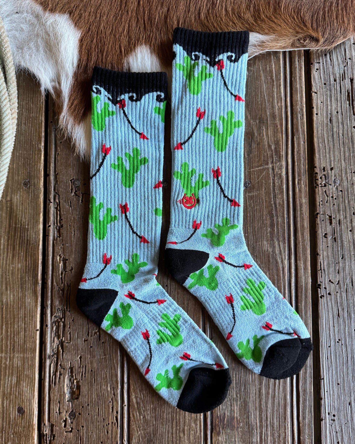 Pair of socks with a floral pattern on a wooden surface