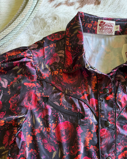 Floral-patterned shirt with a visible brand tag on a neutral background
