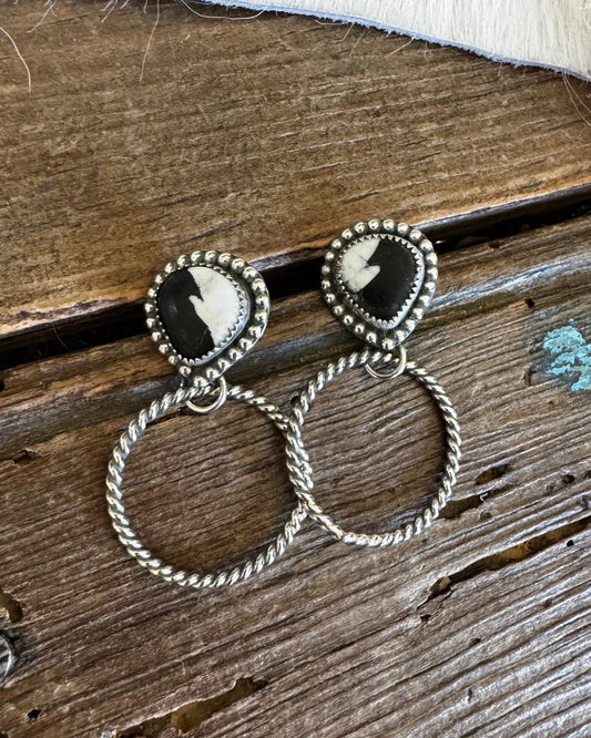Pair of earrings on a wooden surface