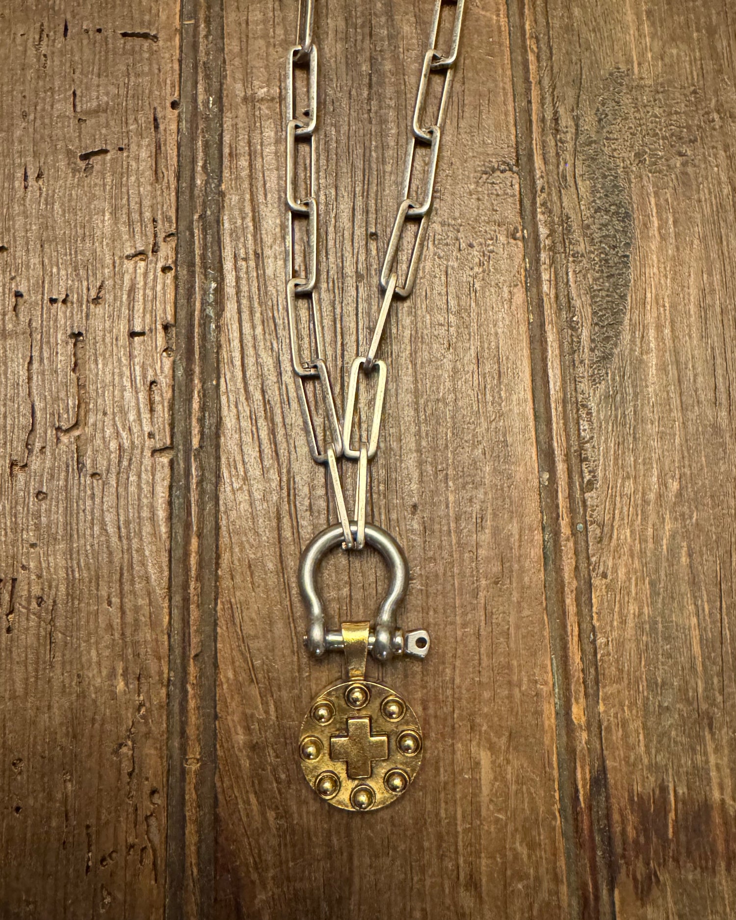 Metal chain with a clasp on a wooden surface