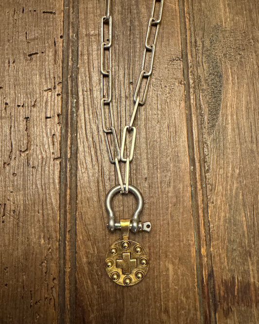 Metal chain with a clasp on a wooden surface