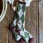 Plaid socks on a wooden surface with a cowhide in the background