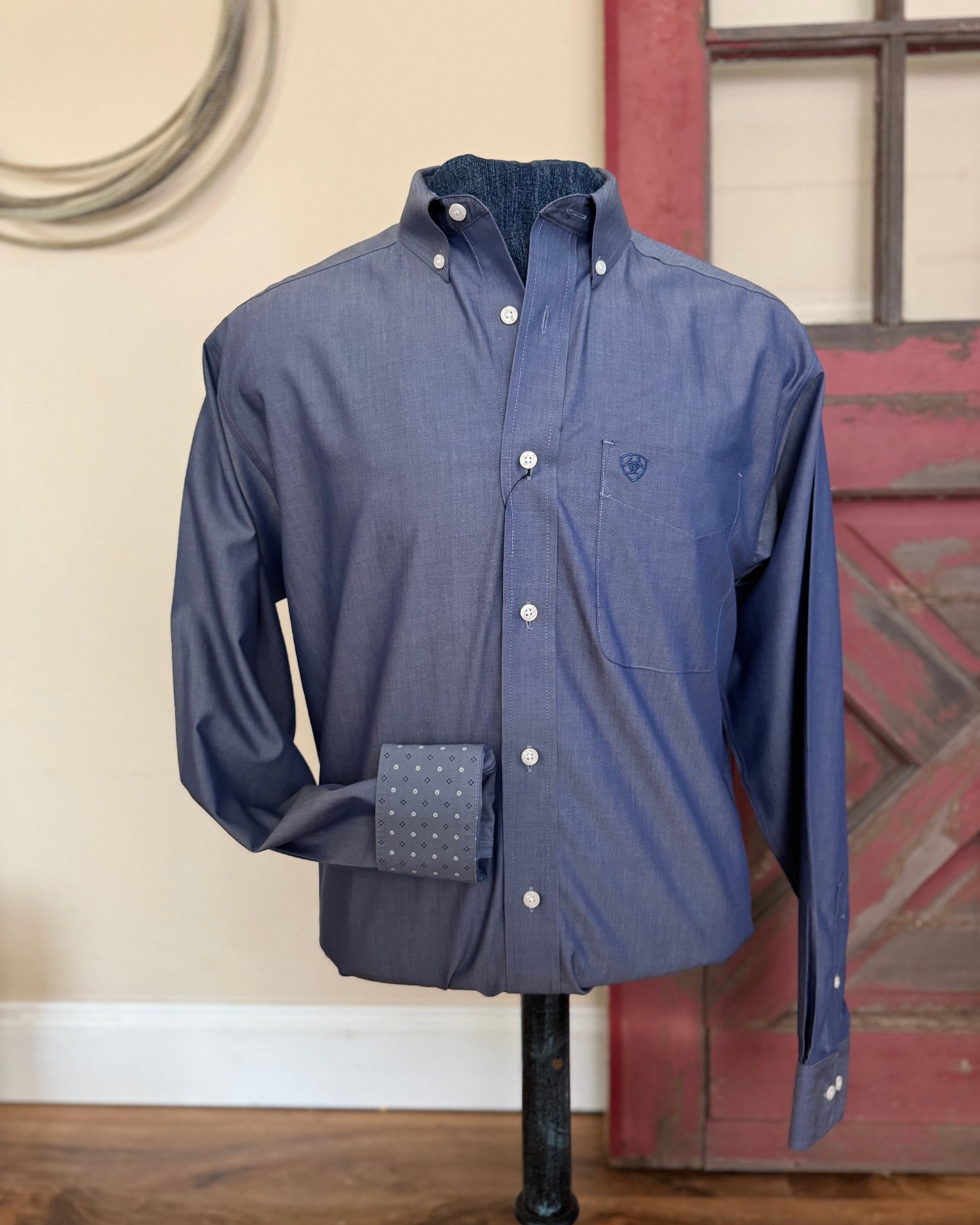 Blue shirt on a mannequin against a rustic background