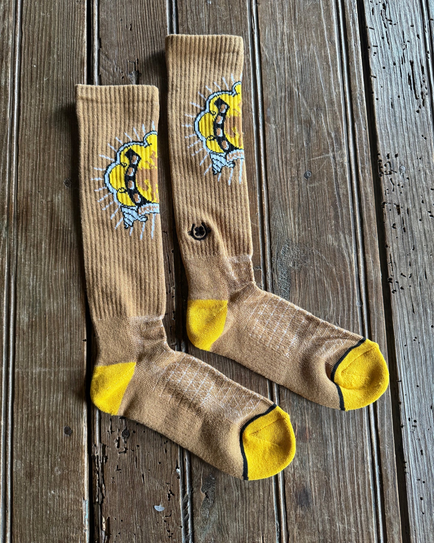 Lucky Bucking Cowgirl Performance Socks (Tan) on rustic wood background